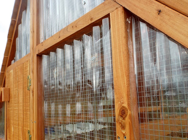 Picture of coop with panels added to prepare for winter weather.